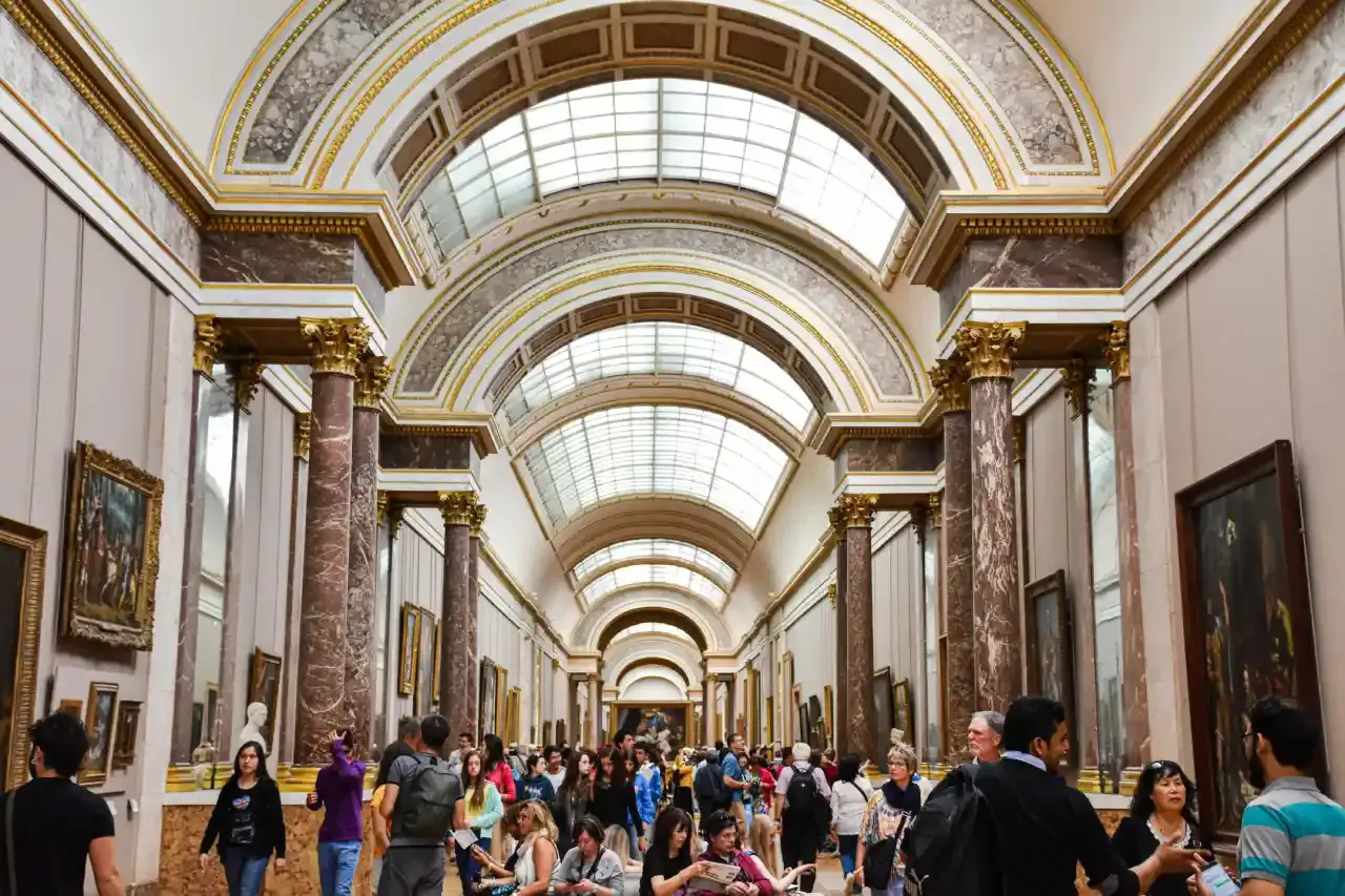 Tourists inside the Louvre Museum
