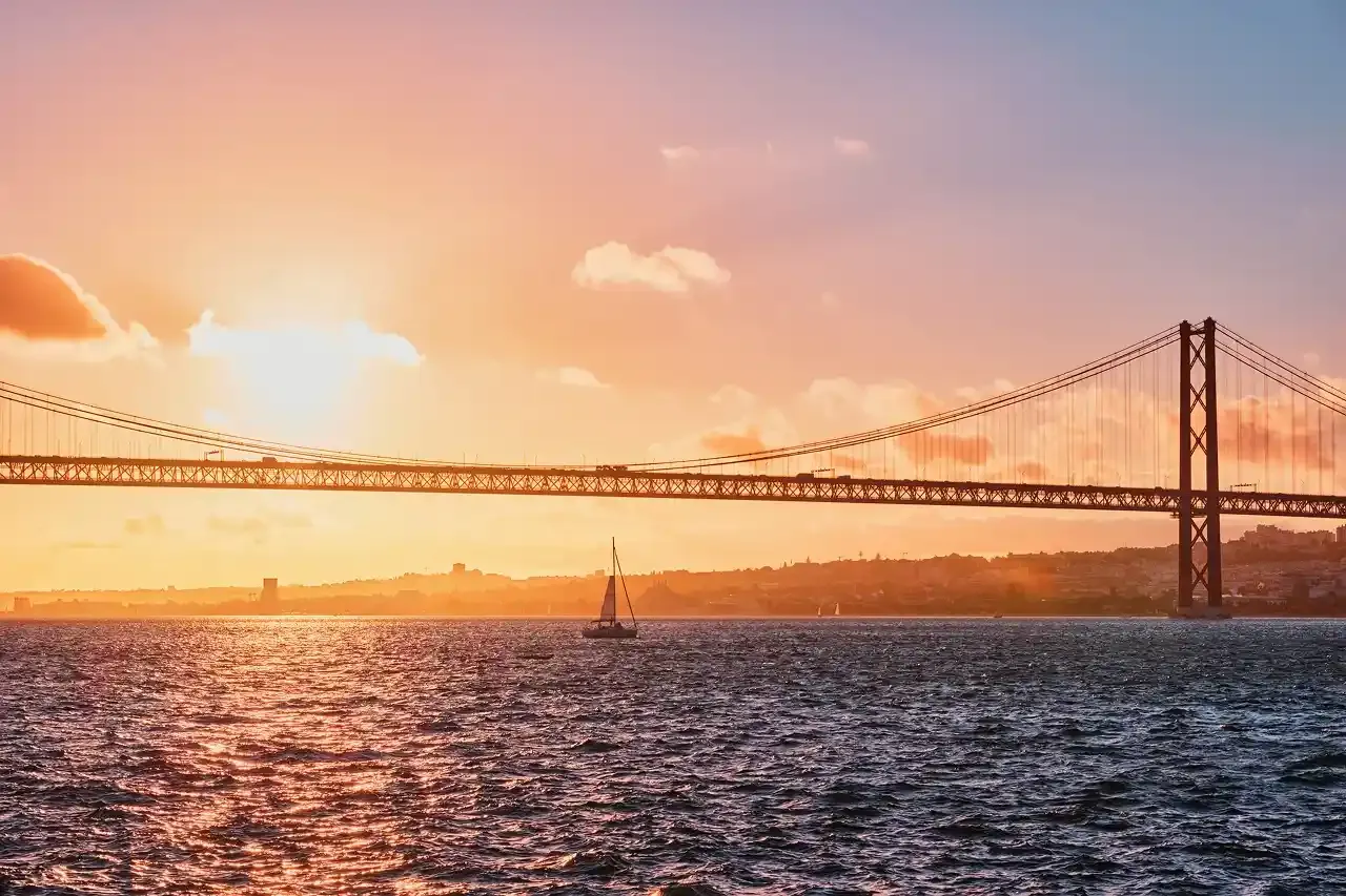 View of 25 de abril Bridge over Tagus River at sunset