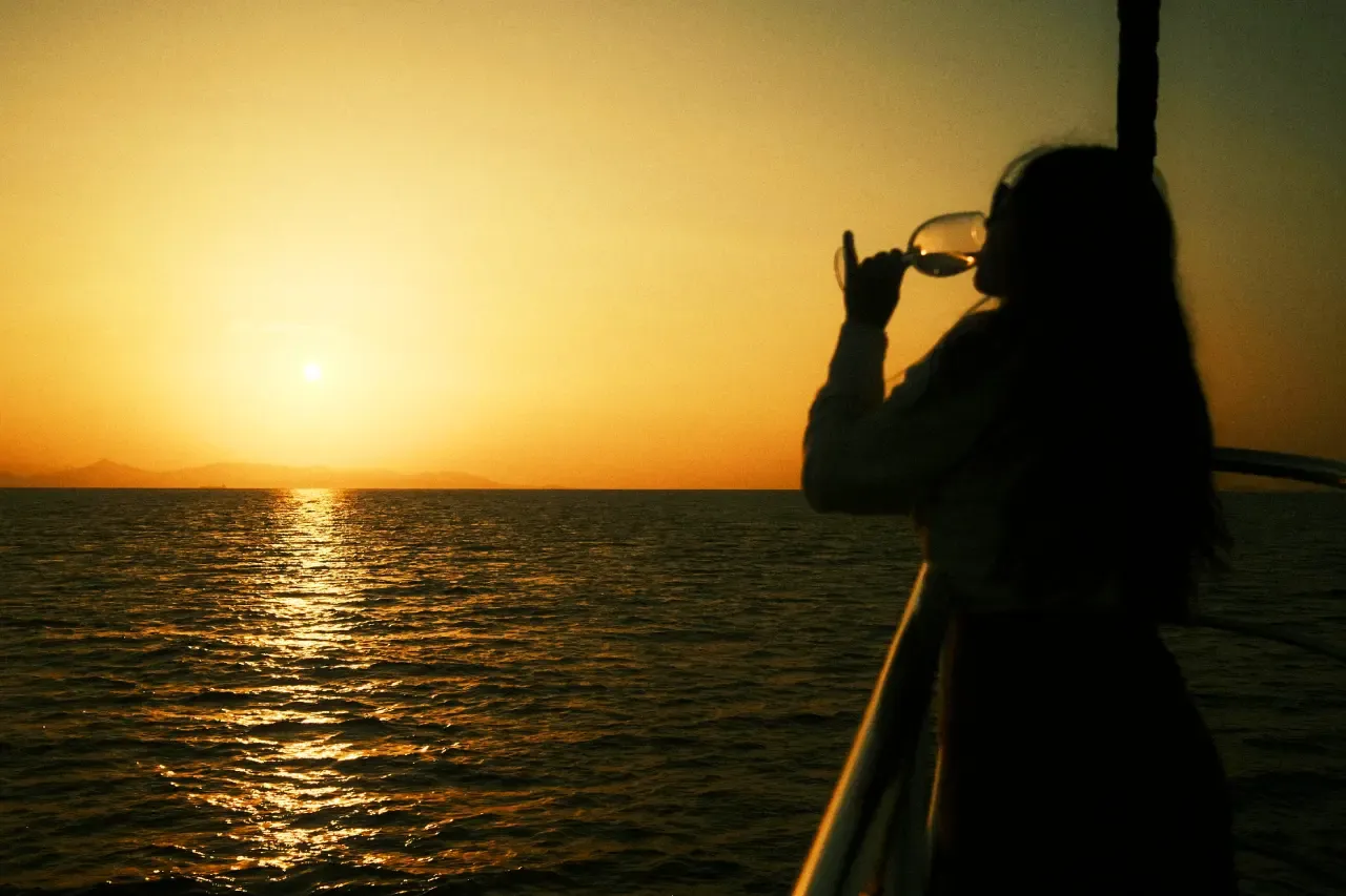 Woman drinking wine on a cruise in Lisbon